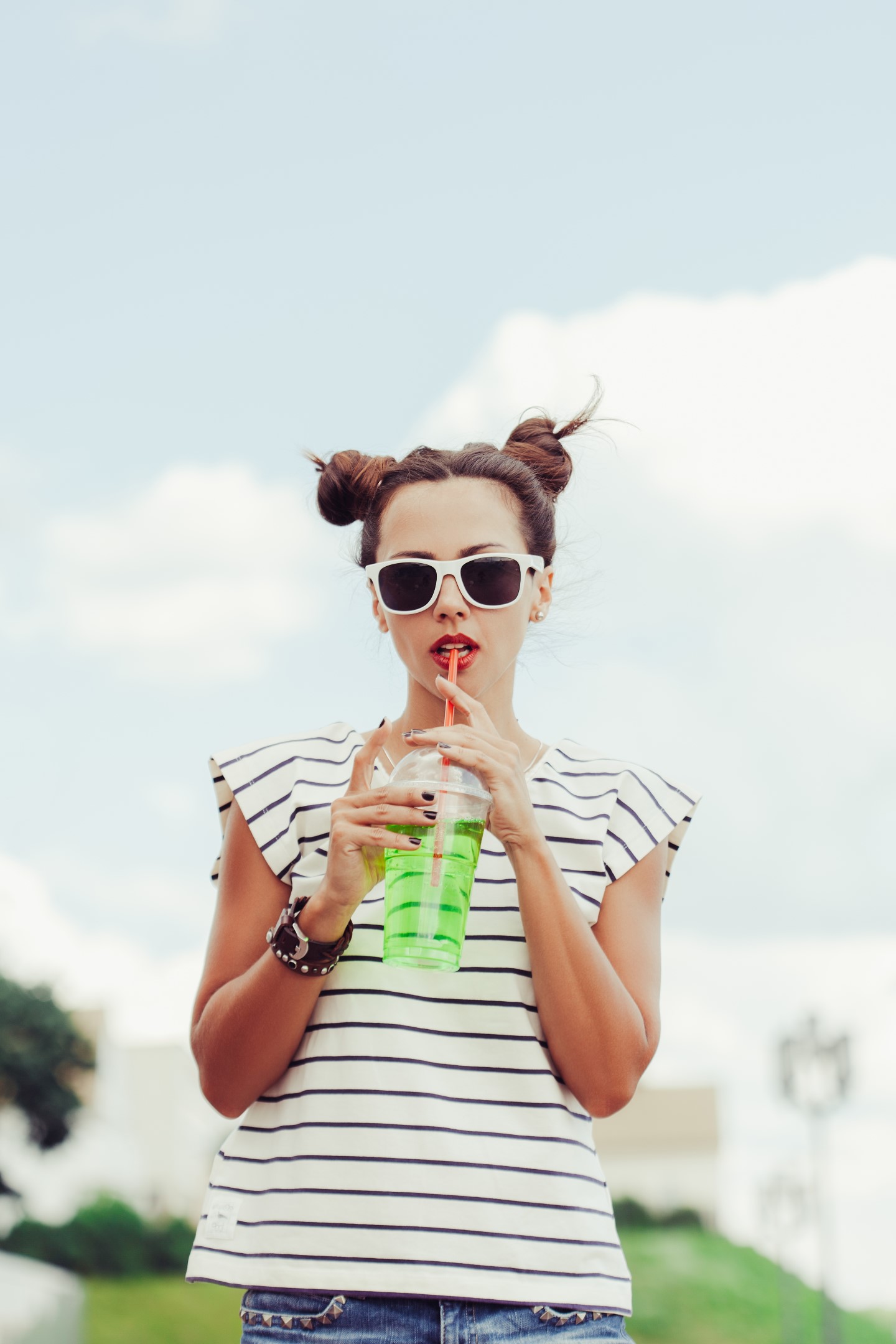 Funky Woman Drinking Water Against The Sky